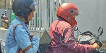 Bangalore Woman Working on Laptop in Traffic