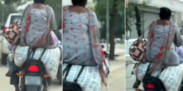 Pillion Sits on Sack of Flour on Bike on Road