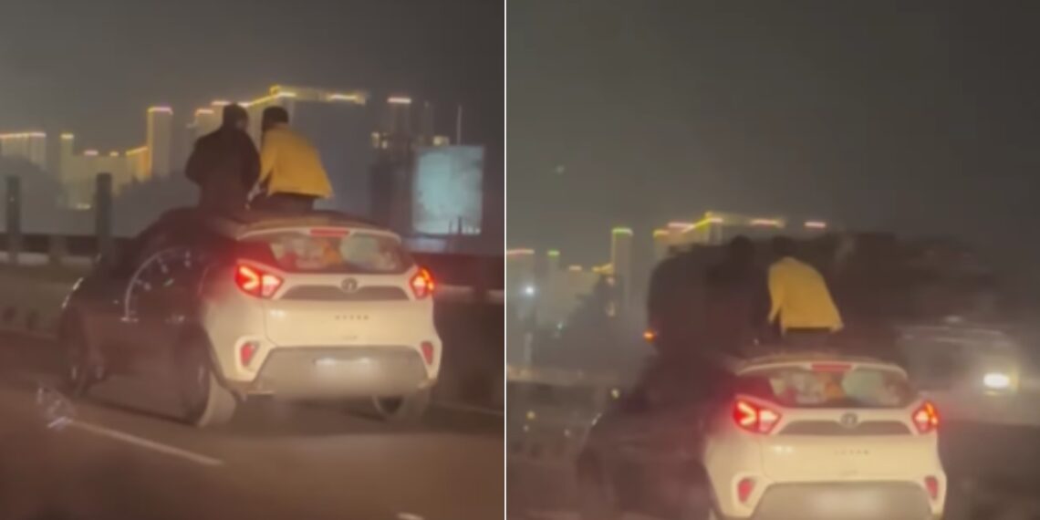 Two Men Sitting on Sunroof of Tata Nexon